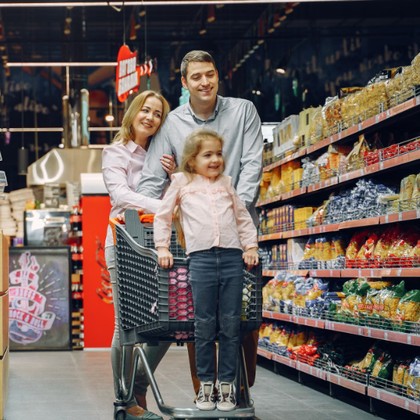 Family shopping a well-stocked grocery aisle